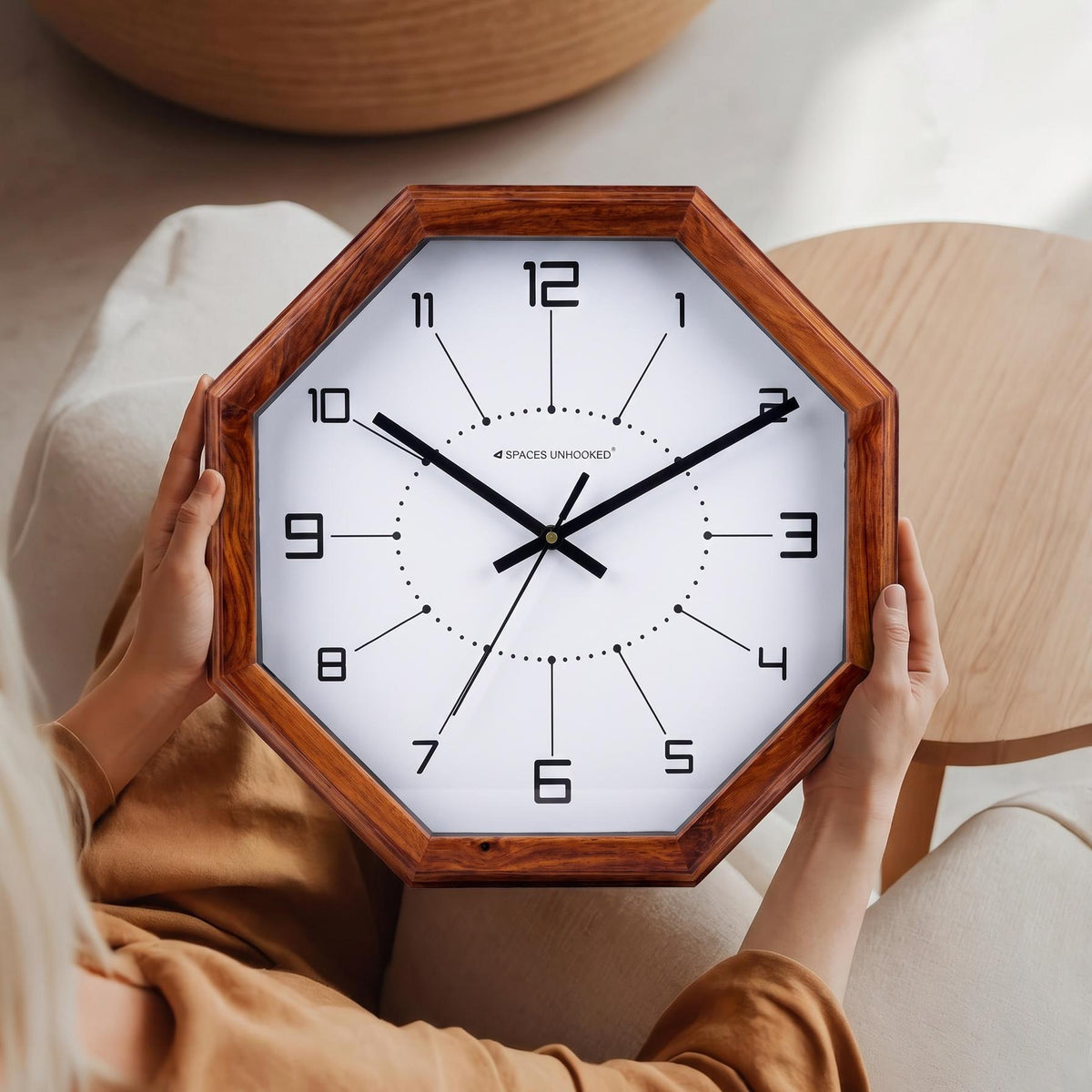 Close-up of squared numerals joined by fine lines to a dotted ring on a white clock dial