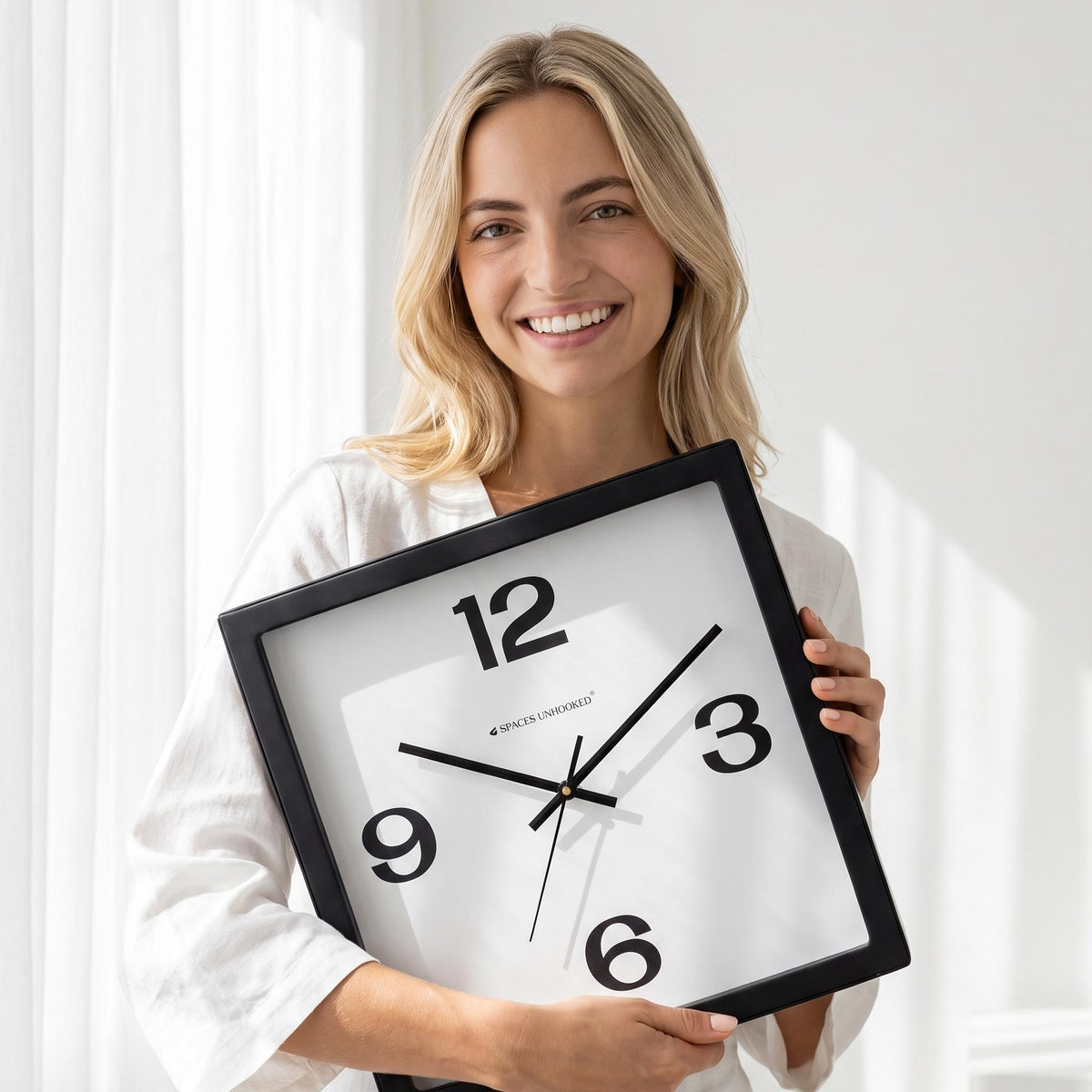 Bold 12-3-6-9 wall clock above a sofa in a modern living room
