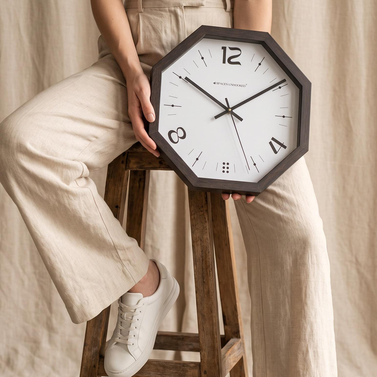 Close-up of bold calligraphic 12, 4 and 8 numerals on a white octagonal wall clock dial