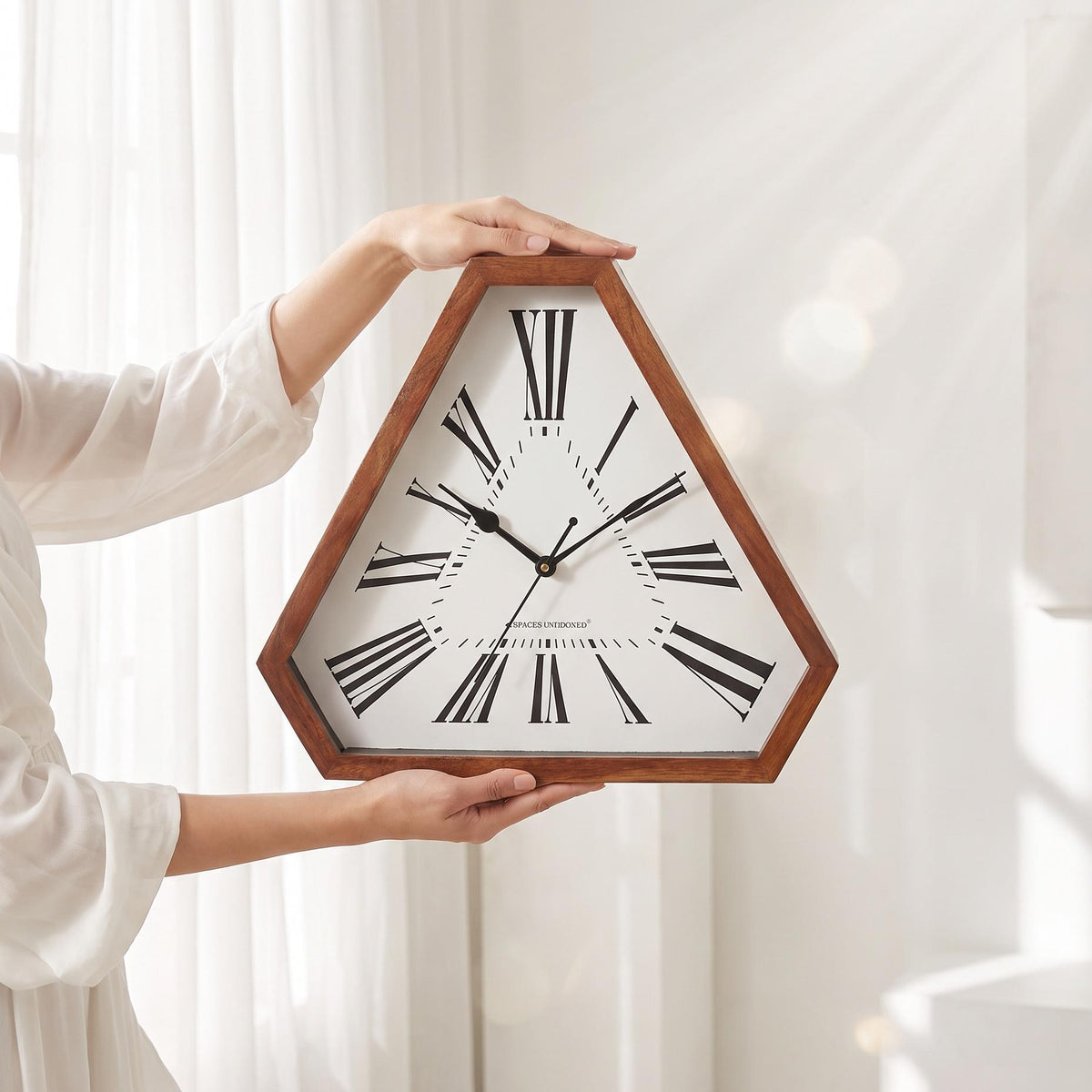 Bold Roman numeral triangular wall clock as a focal point above a living room fireplace