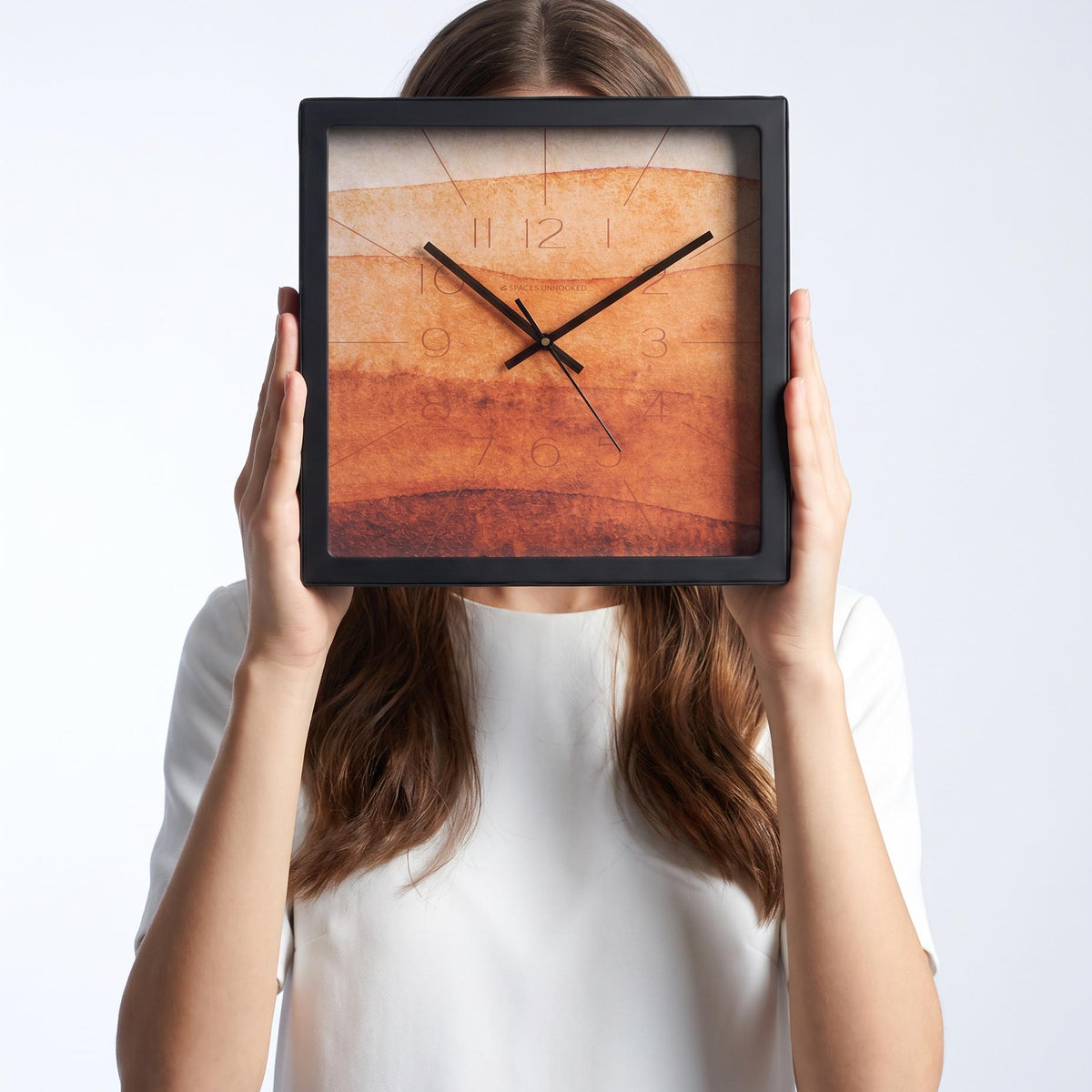 Terracotta watercolour wall clock above a living room wall above a sofa