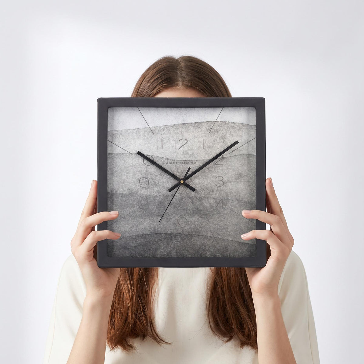 Ash grey watercolour wall clock above a living room wall above a console