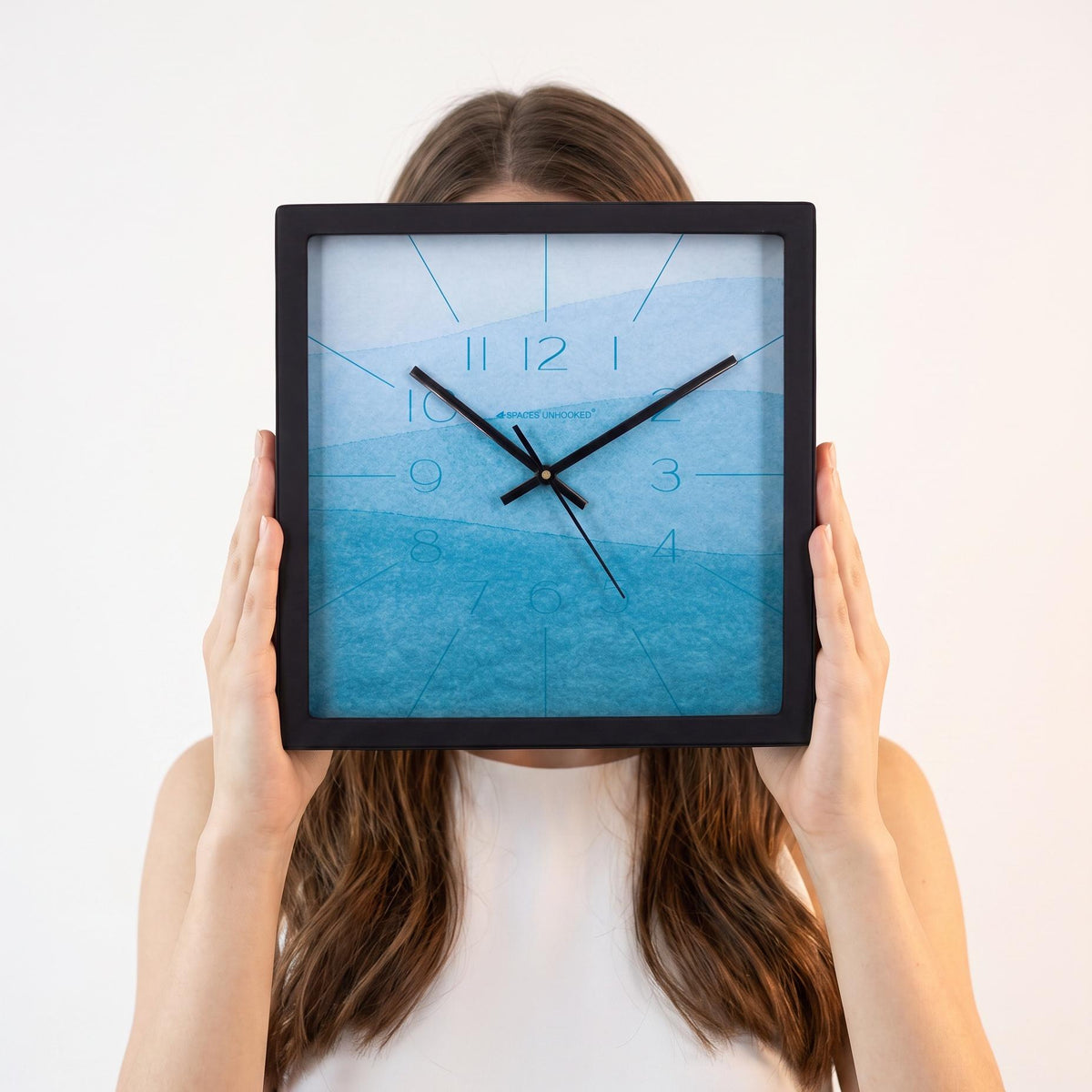Sky blue watercolour wall clock above a bedroom wall above a dresser