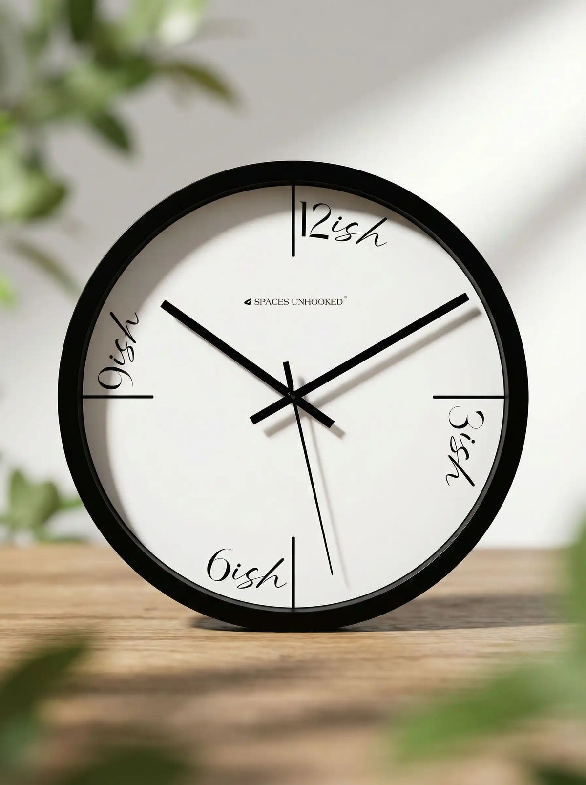 Spaces Unhooked minimalist black wall clock styled on a modern tabletop in a contemporary home interior