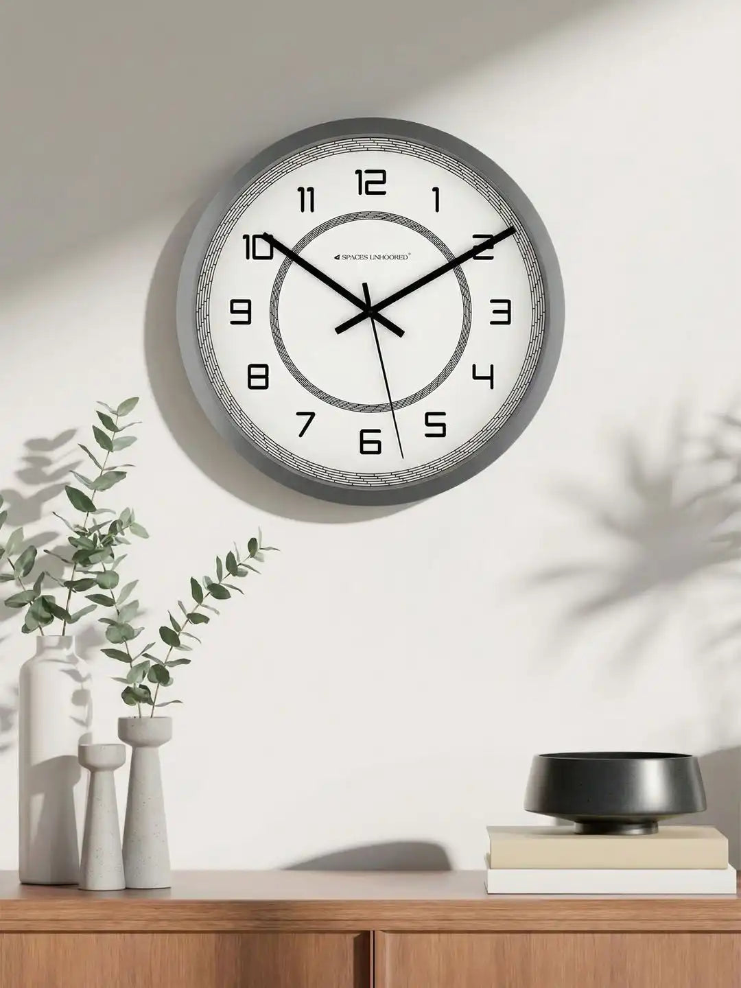 Lifestyle AI View – Premium Silent Wall Clock Mounted on Wall with Eucalyptus and White Vase Decor