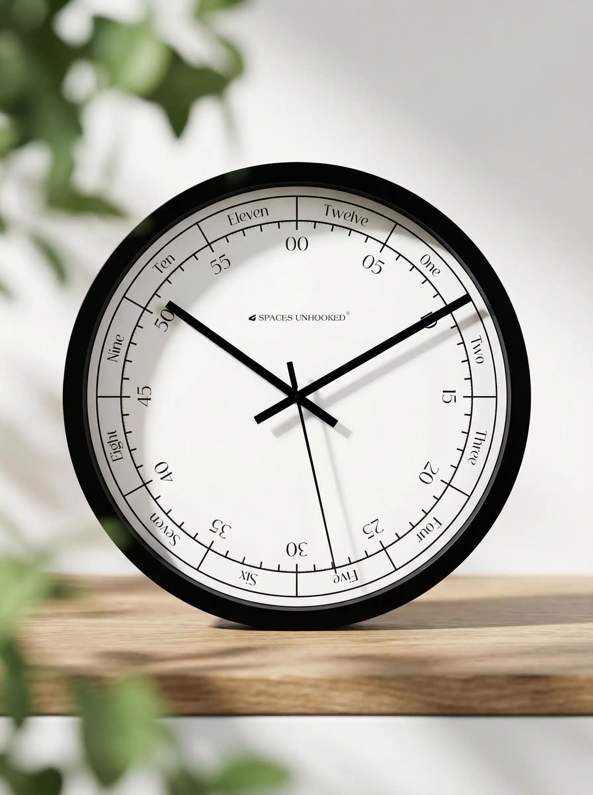 Lifestyle AI View – Premium Silent Wall Clock on Wooden Table with Green Leaves