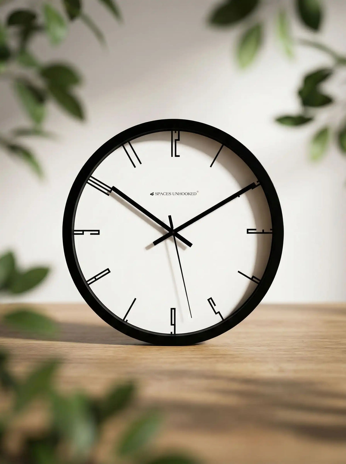Lifestyle AI View – Premium Silent Wall Clock on Wooden Table with Green Leaves