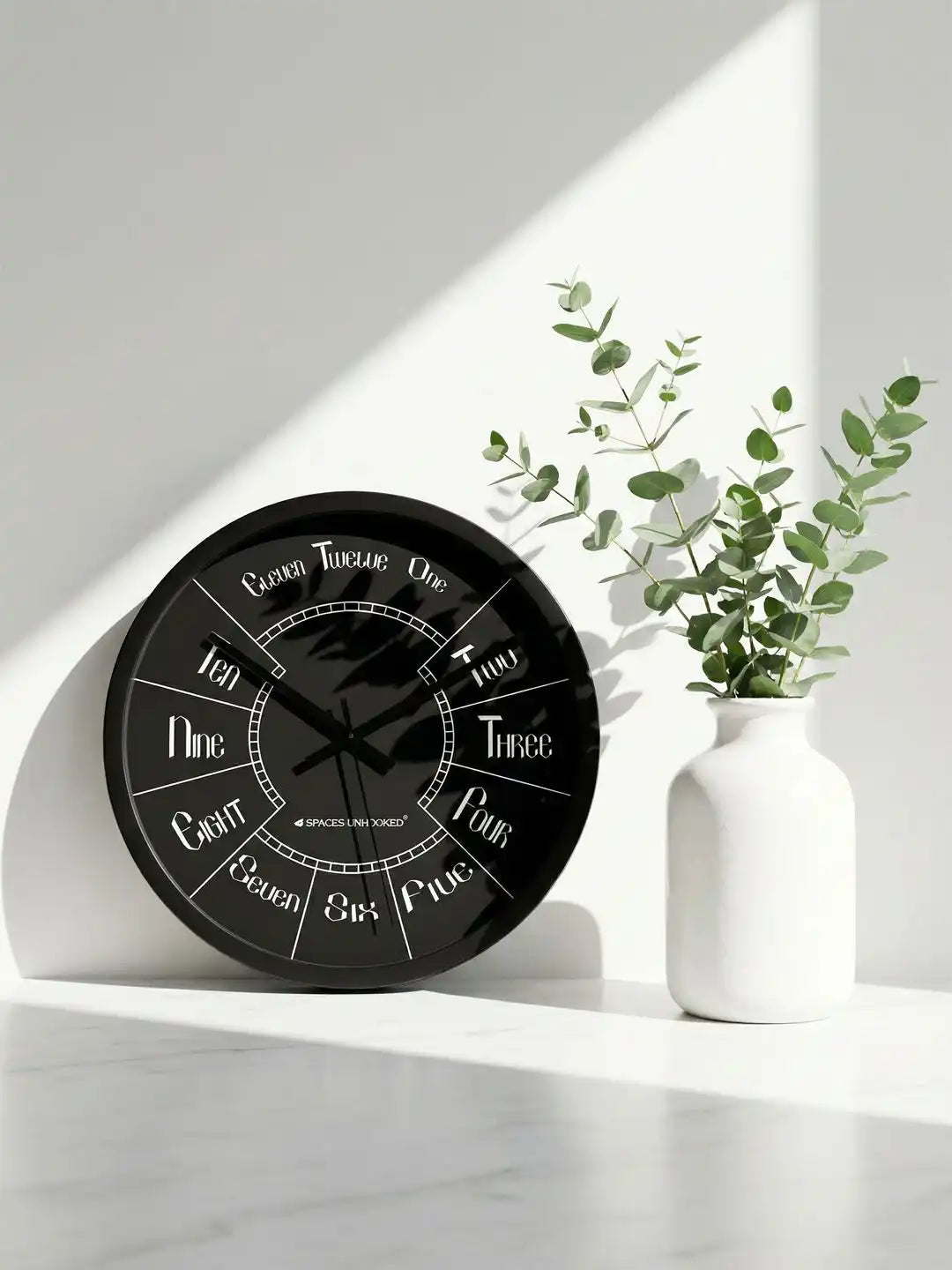 Lifestyle AI – Designer wall clock placed on marble shelf with eucalyptus plant