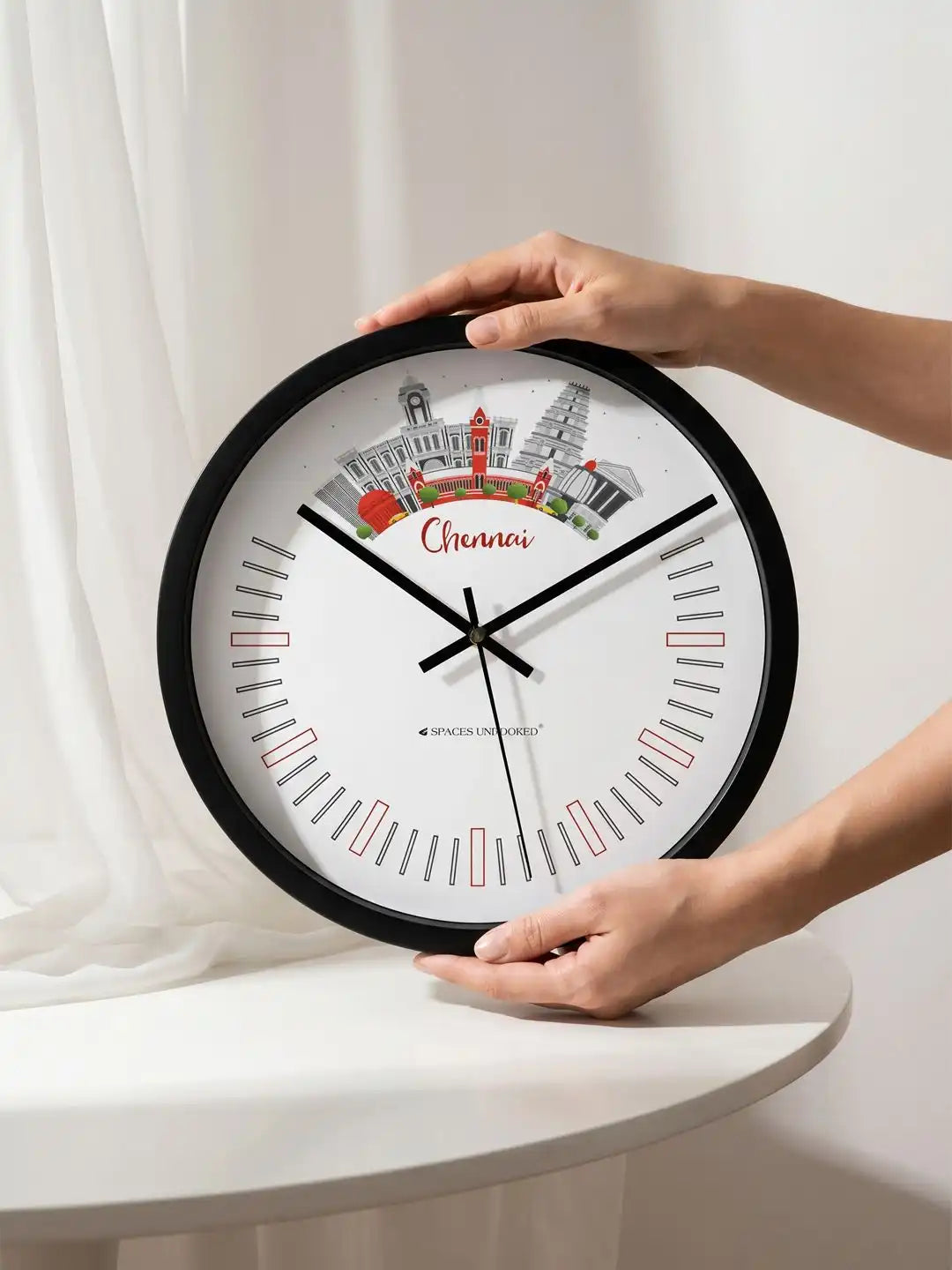 Lifestyle AI – Designer wall clock being held by hands on white table setting
