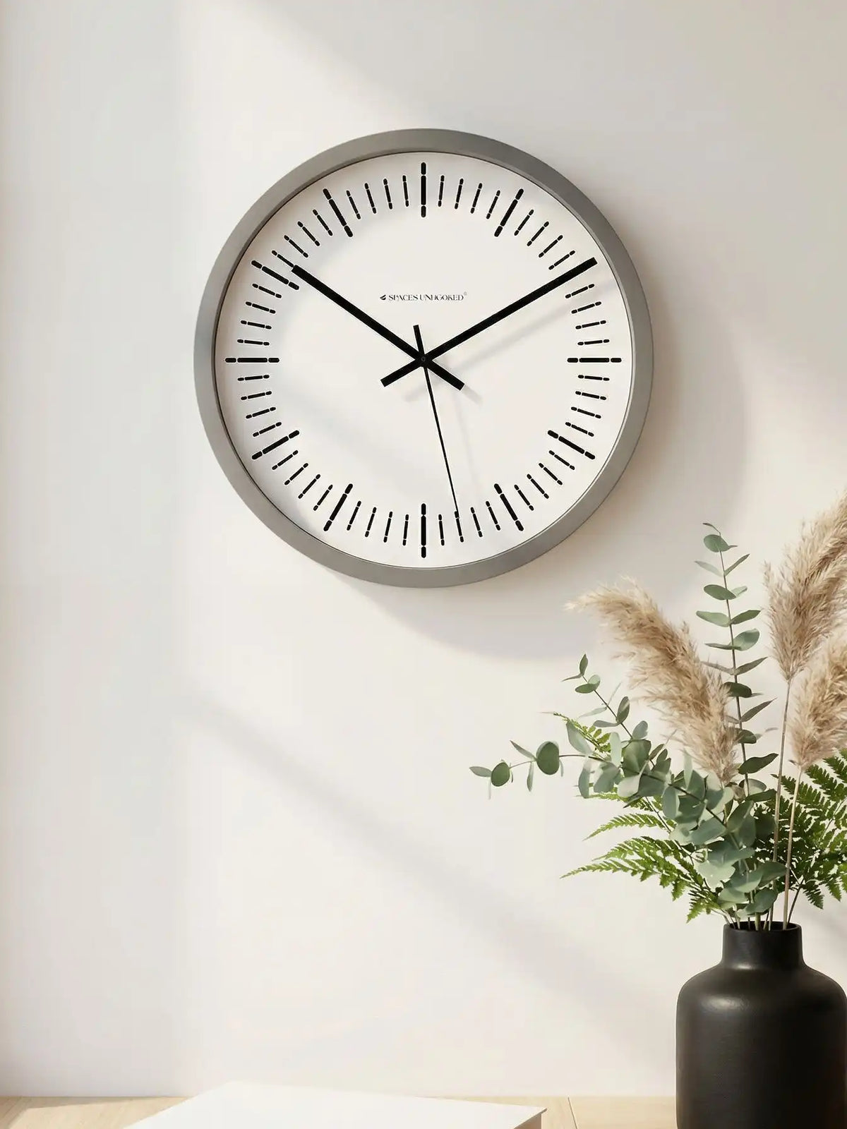 Lifestyle M – Silent wall clock being mounted on wall by hands with bracelet