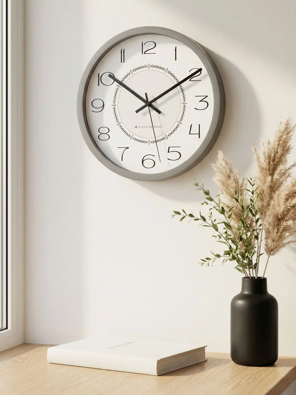 Lifestyle M – Designer wall clock displayed above wooden table with plants