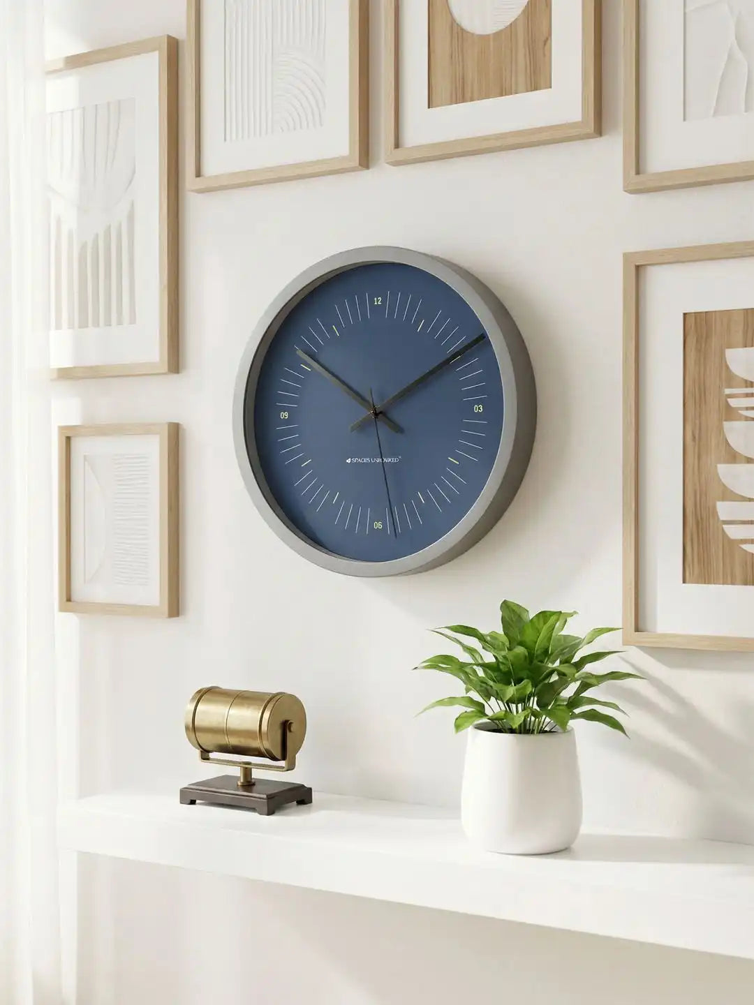 Lifestyle M – Silent wall clock displayed on gallery wall with framed art and plant