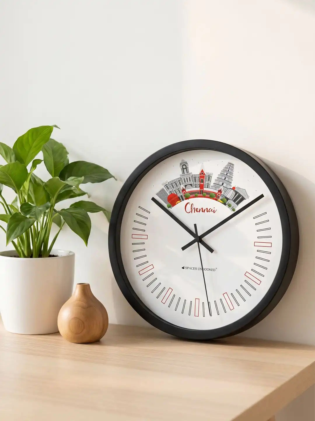 Lifestyle M – Silent wall clock placed on wooden table beside plant and vase decor