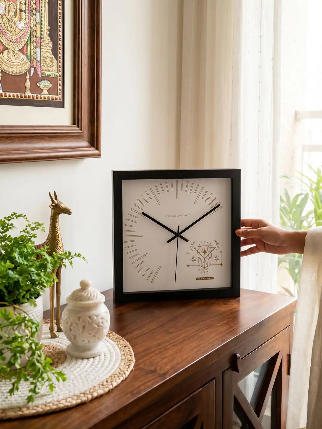 Square Dark Wood Frame Wall Clock with Gold Capricorn Design on Wooden Sideboard - Wooden Wall Clock for Living Room