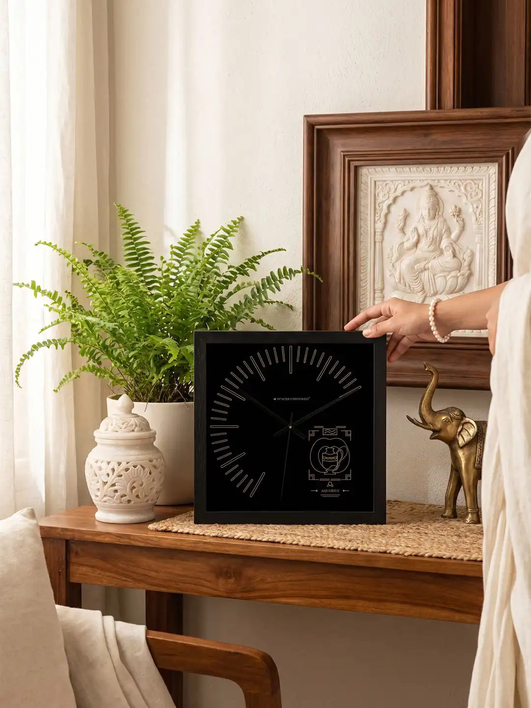 Aquarius zodiac wooden wall clock displayed in living room interior with black wood frame, silent wall clock and modern home décor