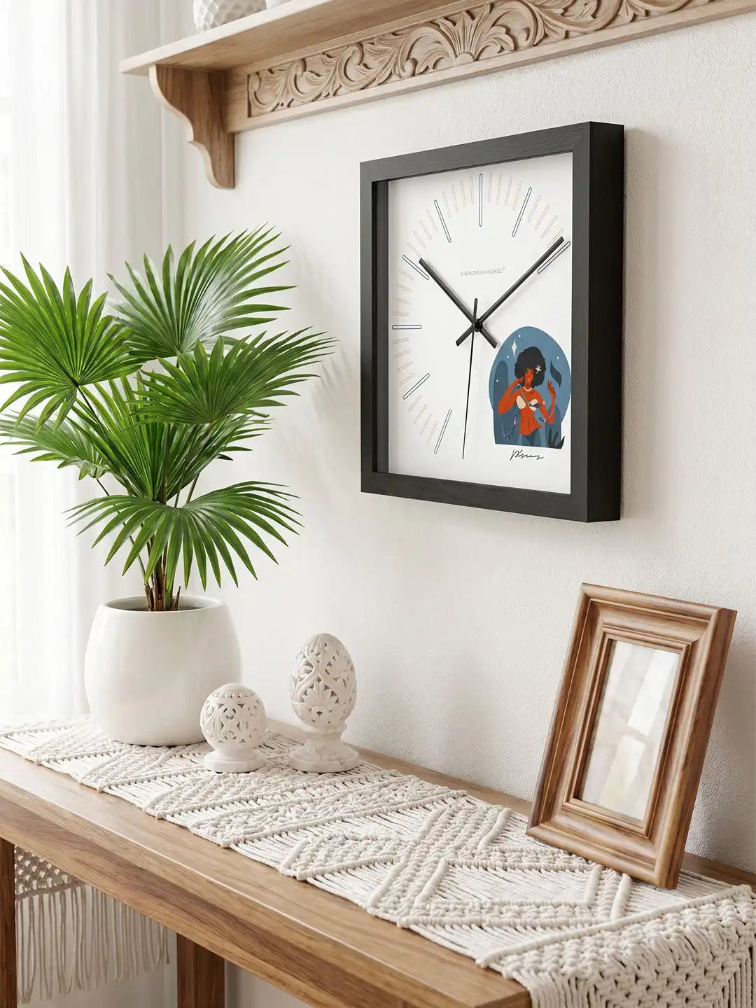 Premium black-framed wall clock with minimalist face and protective packaging box.
