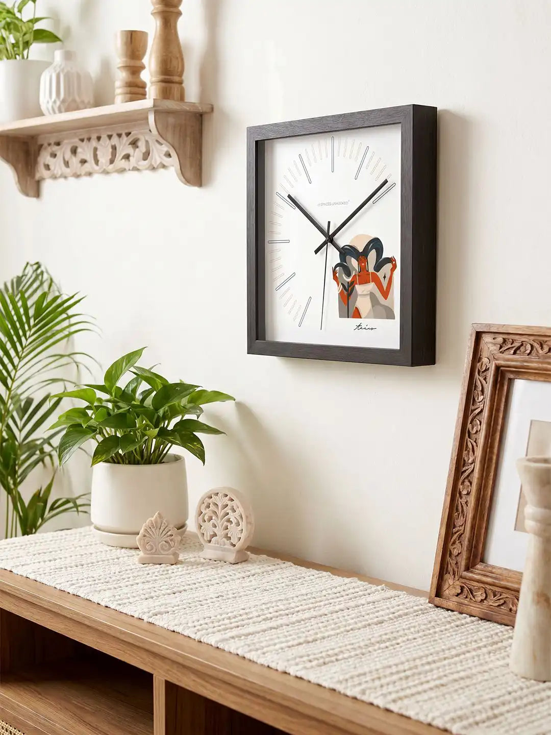 Taurus zodiac wall clock mounted on a wall above a wooden console table, styled with indoor plants, decorative accents, and a neutral-toned interior setting