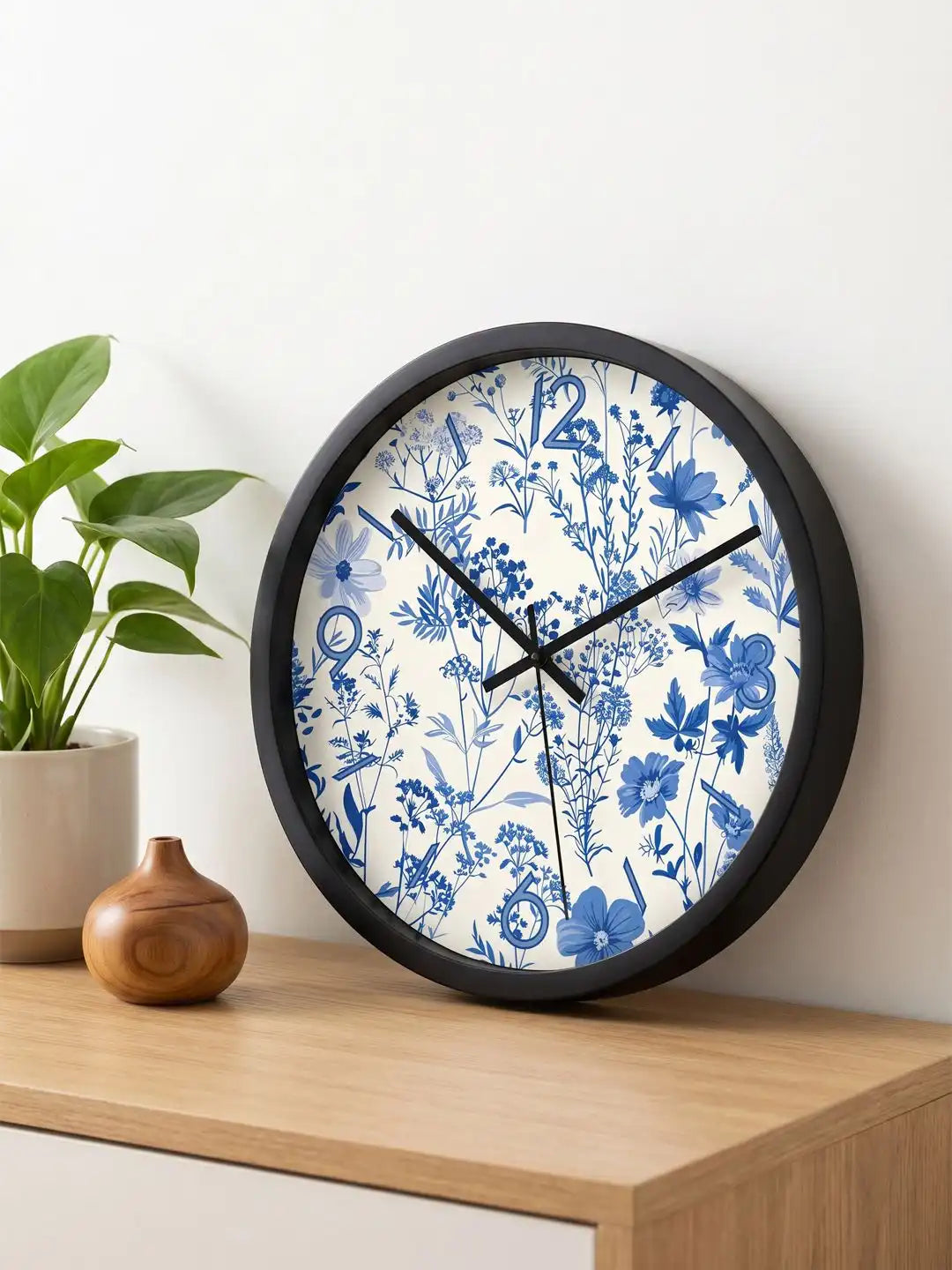 Lifestyle M – Silent wall clock placed on wooden table beside plant and vase decor