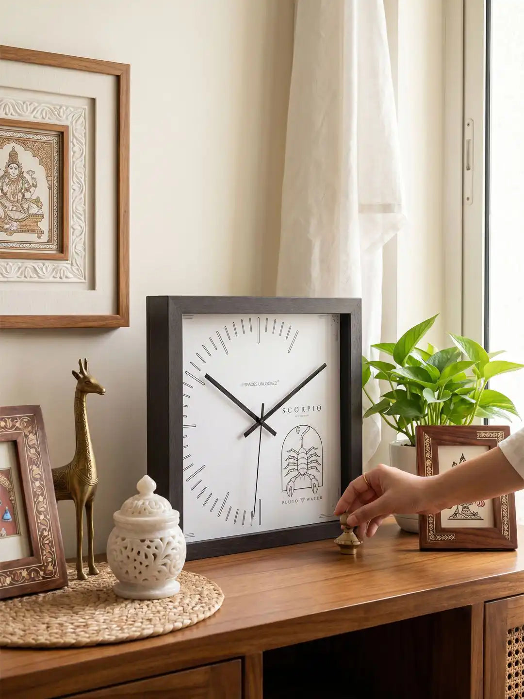 Wooden wall clock Scorpio design placed on console table, natural wood clock aesthetic, wood frame wall clock for elegant home decoration