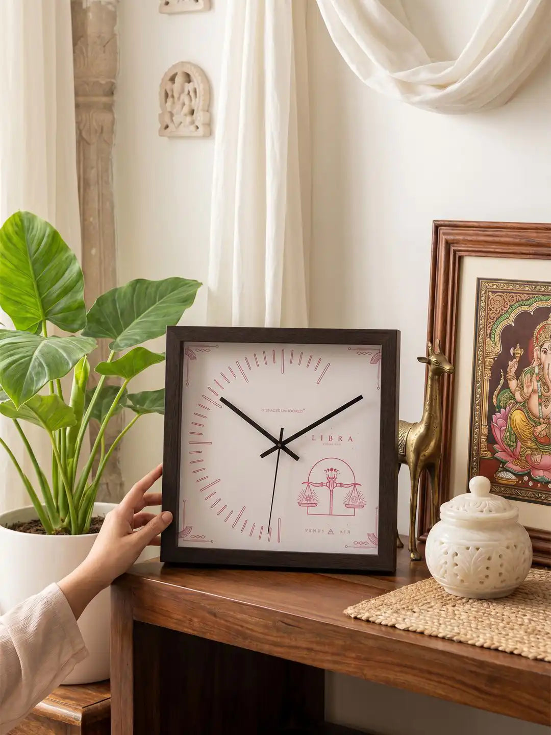 Square Dark Wood Frame Wall Clock with Pink Libra Scales Design on Wooden Console Table - Wooden Wall Clock for Living Room