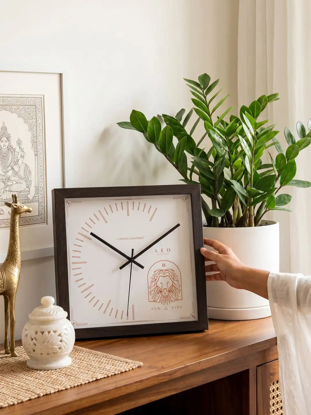 Leo zodiac wall clock styled on a wooden console table, decorative wooden clock with lion motif, premium home décor accessory