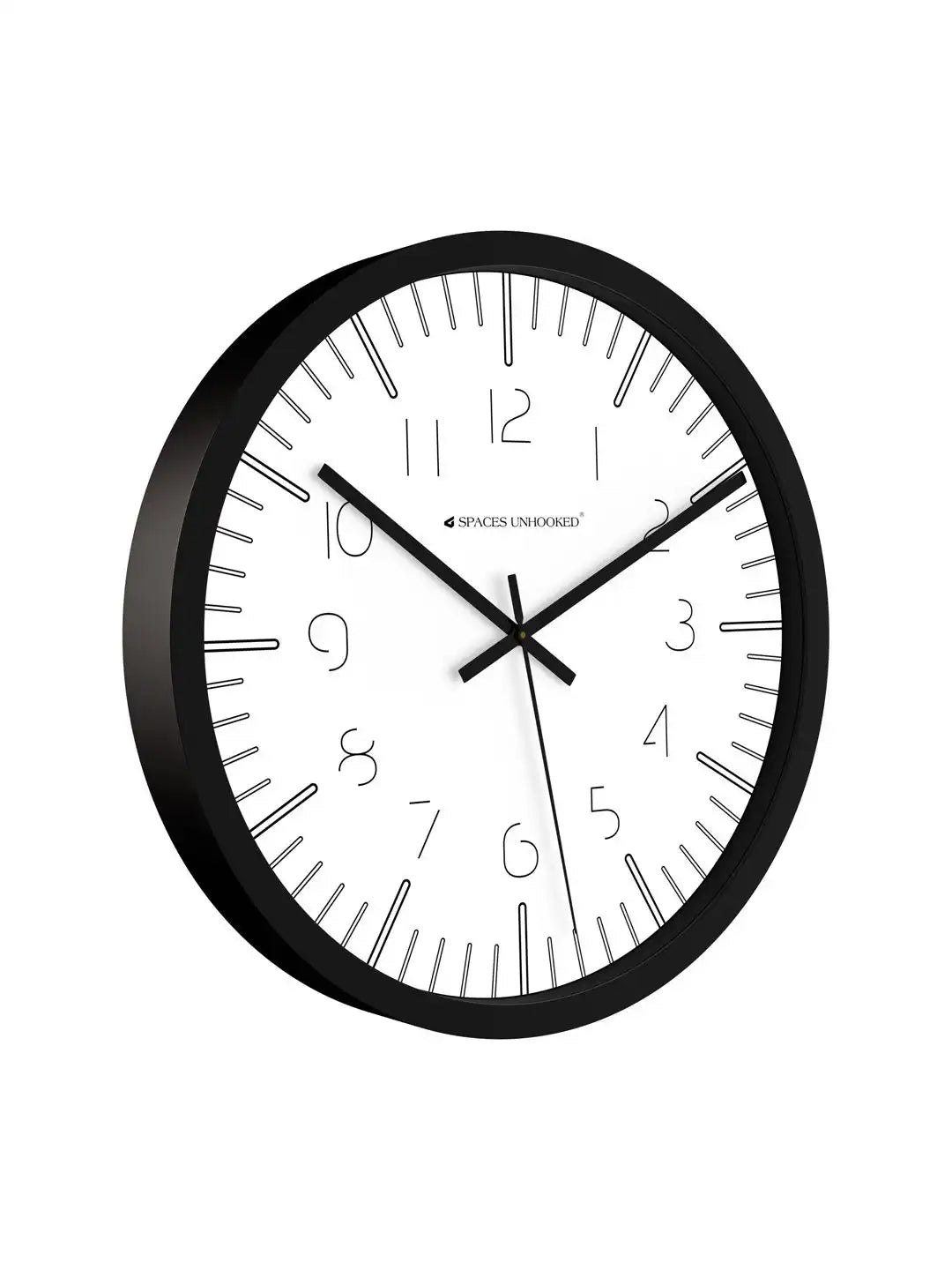 Close-up angled front view of Spaces Unhooked black wall clock with white dial and minimalist Arabic numerals