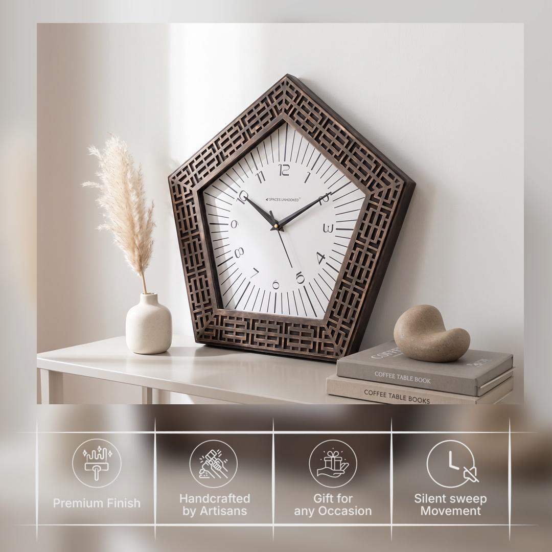 Pentagon bronze wall clock on a study wall beside a bookshelf
