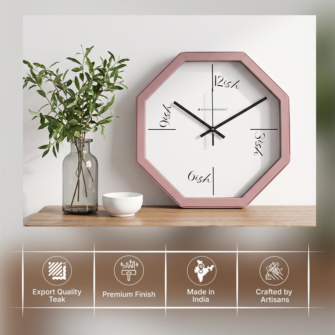 Rose pink octagonal wall clock in a cafe or dressing area with warm wood decor and brass