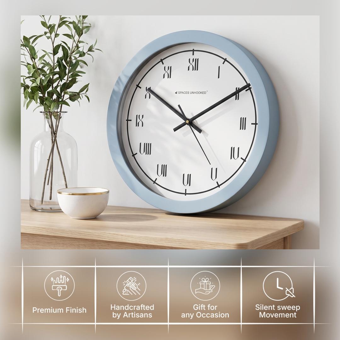 Powder blue wall clock in a bright living room or hallway with pale wood and brass