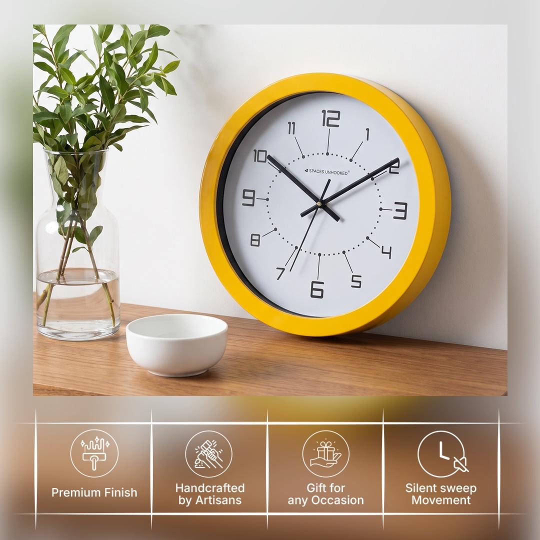 Bright yellow round wall clock above a grey sofa in a modern living room with navy accents