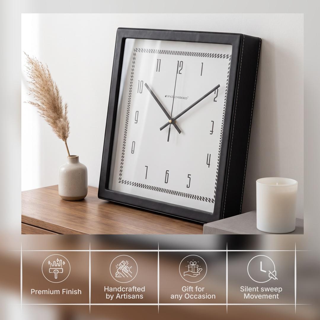 Glossy black hour and minute hands with a thin second hand on a white dial