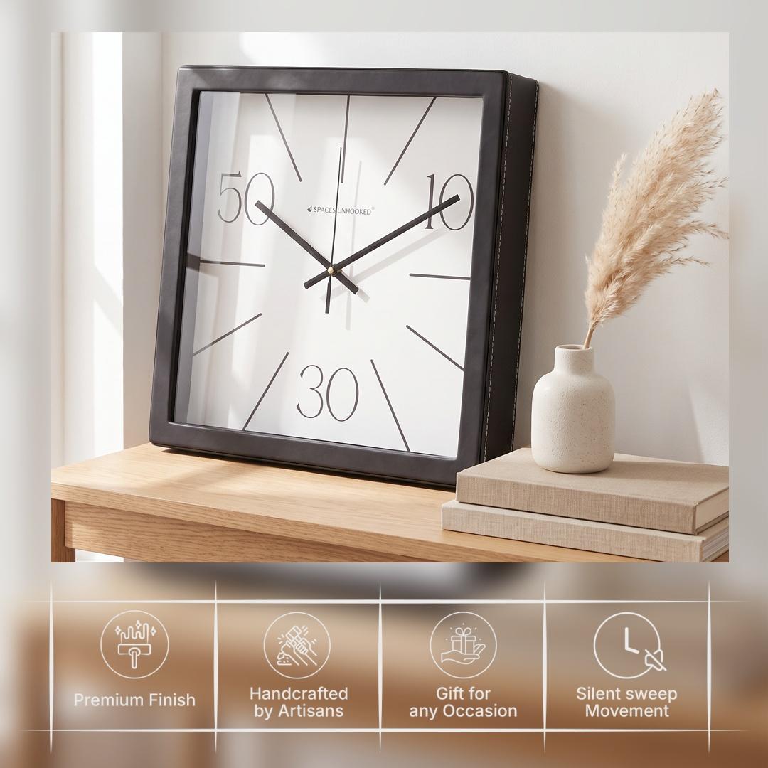 Black hour and minute hands with a thin second hand over radiating lines on a white dial