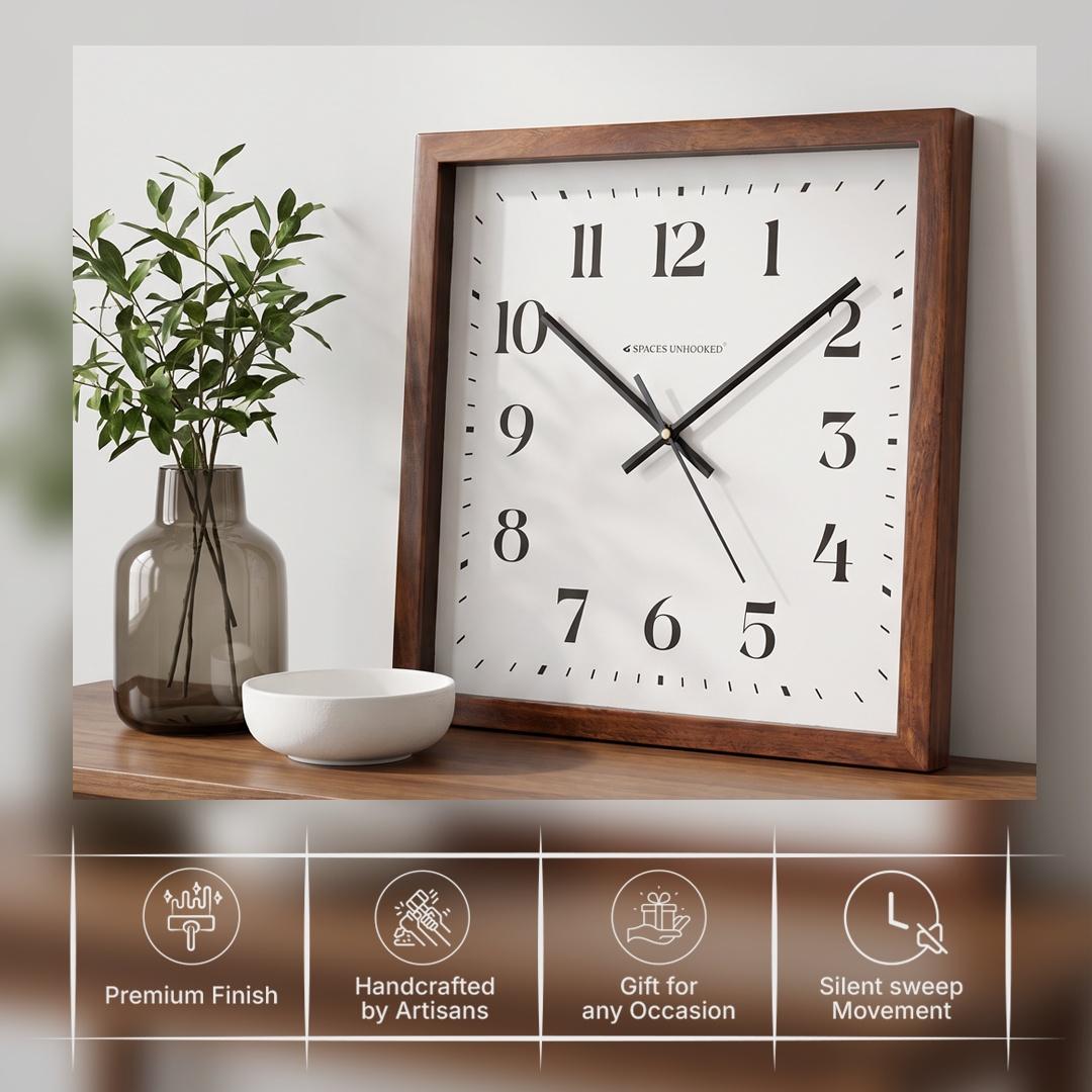 Slim black hour, minute and second hands over fine minute markers on a square wall clock dial