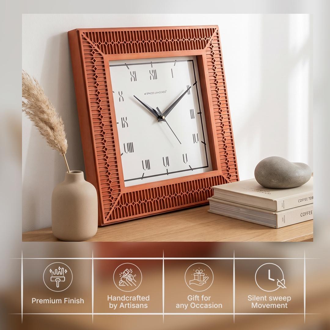 Terracotta roman wall clock on a hallway wall beside a console