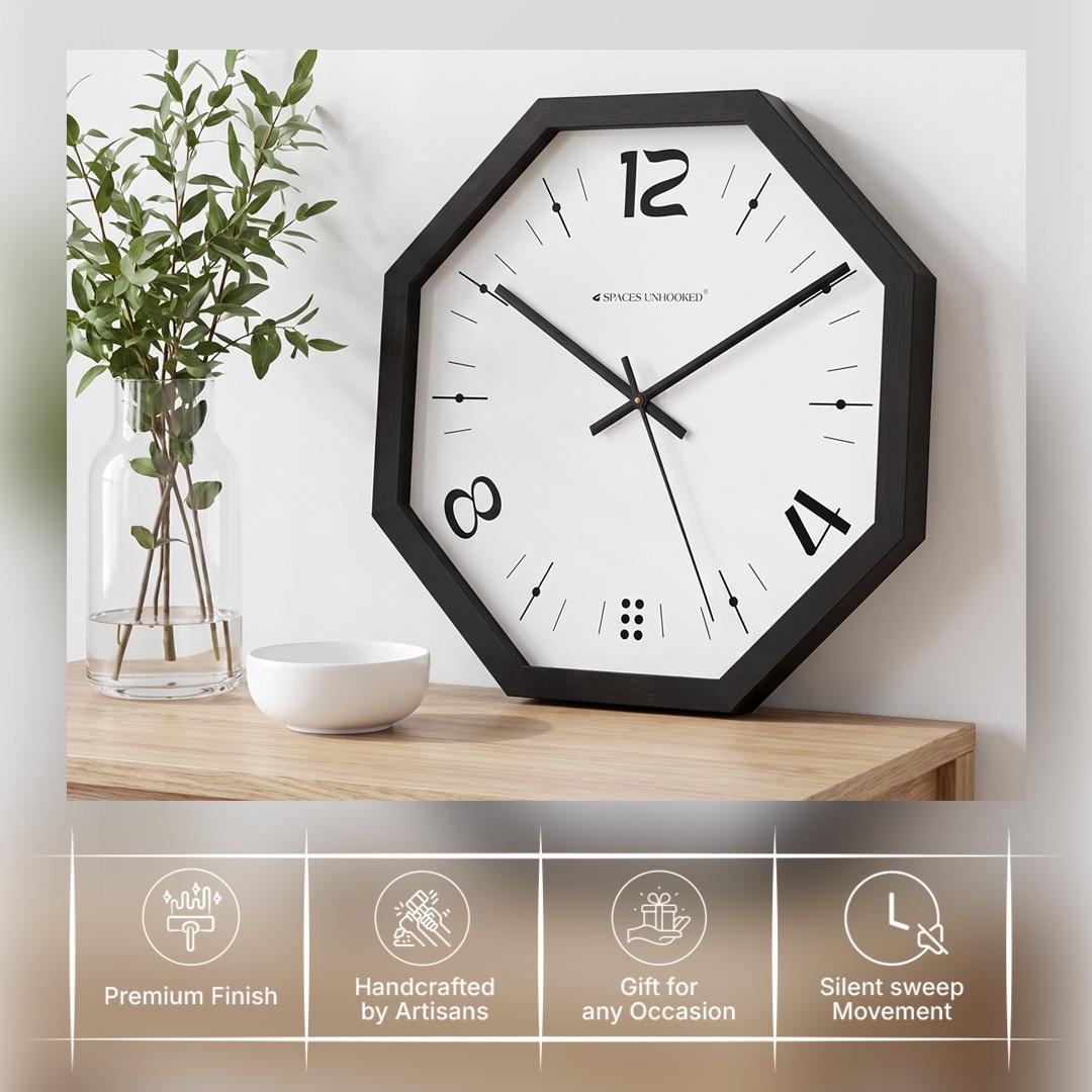 Black octagonal wall clock in a studio, gallery or kitchen with concrete and light wood