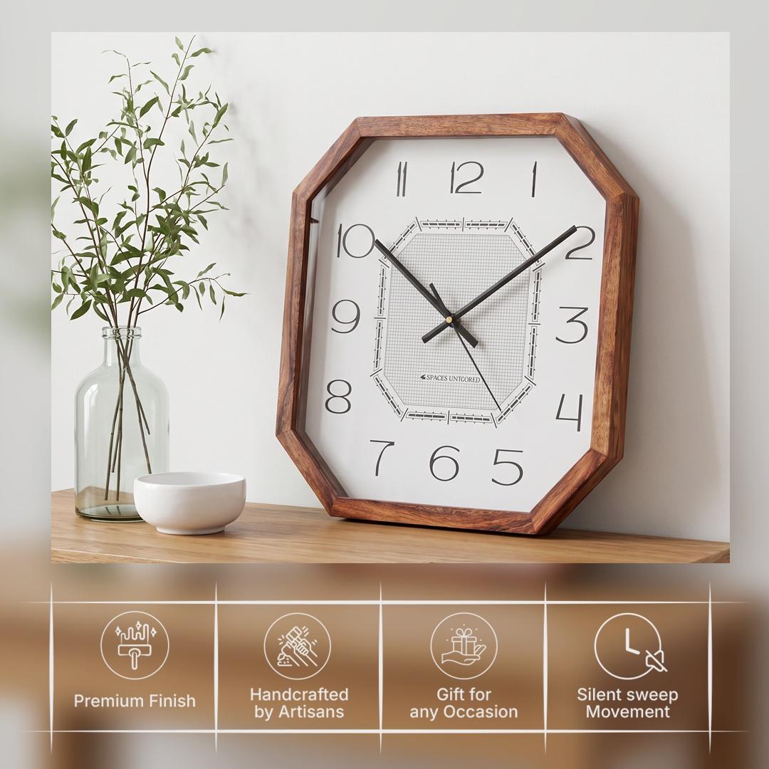 Slim elongated black numerals 1 to 12 on the white dial of a cut-corner wooden wall clock