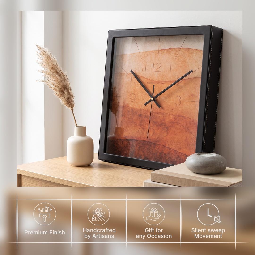 Black hour and minute hands over a terracotta watercolour dial with faint numerals