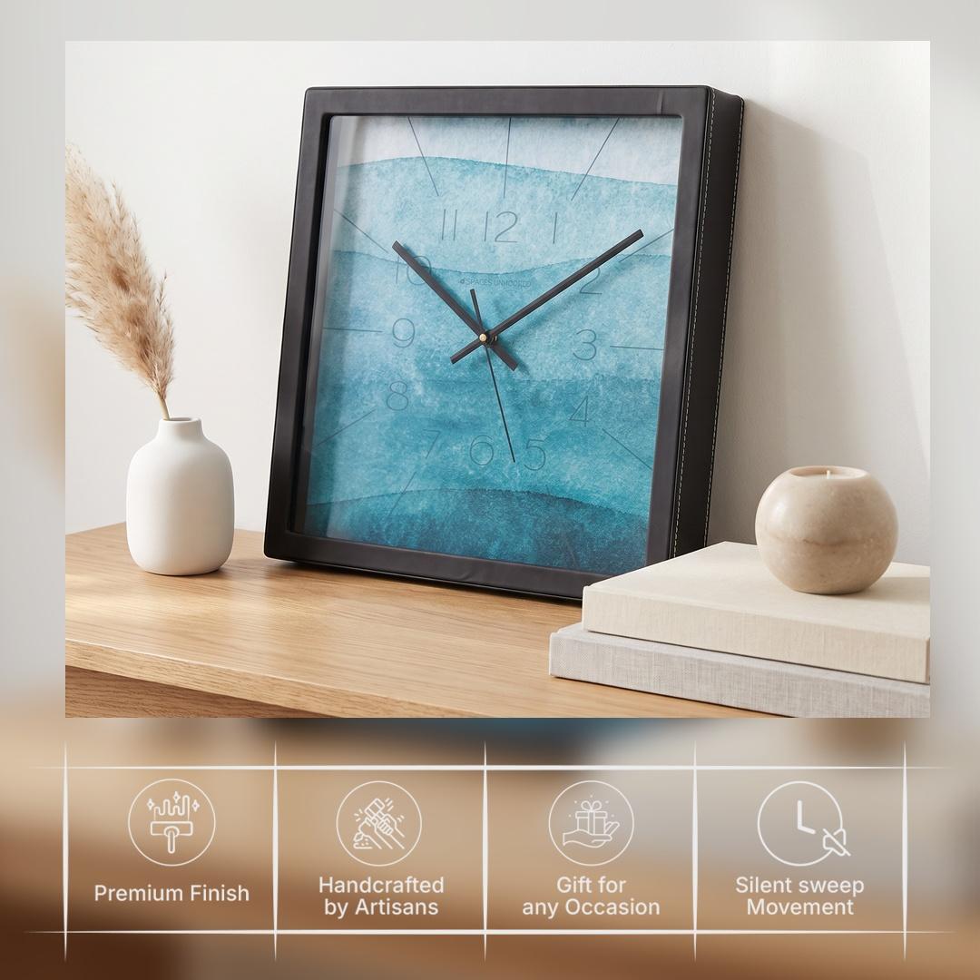 Black hour and minute hands over a teal watercolour dial with fine radiating lines