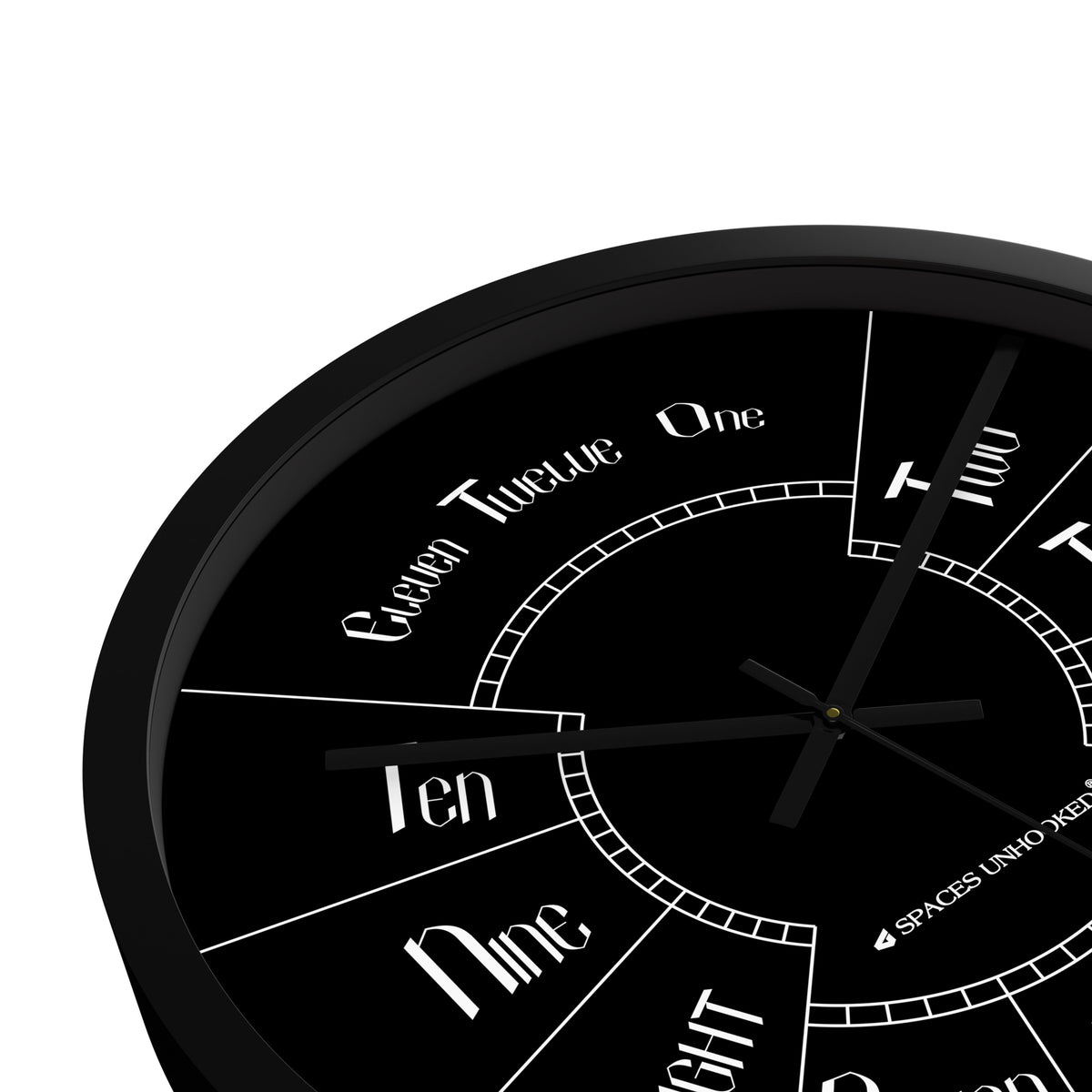 Spaces Unhooked Numeral Wall Clock with a black dial featuring words for hours in elegant typography.