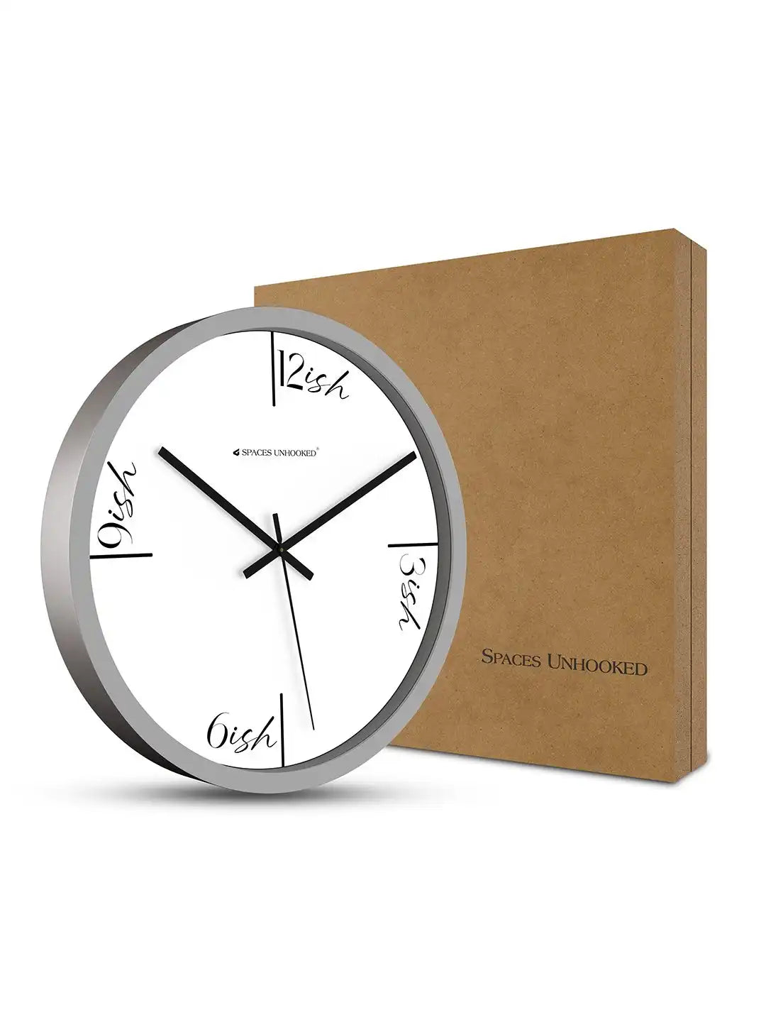 Grey-framed white dial wall clock leaning against its brown kraft packaging box