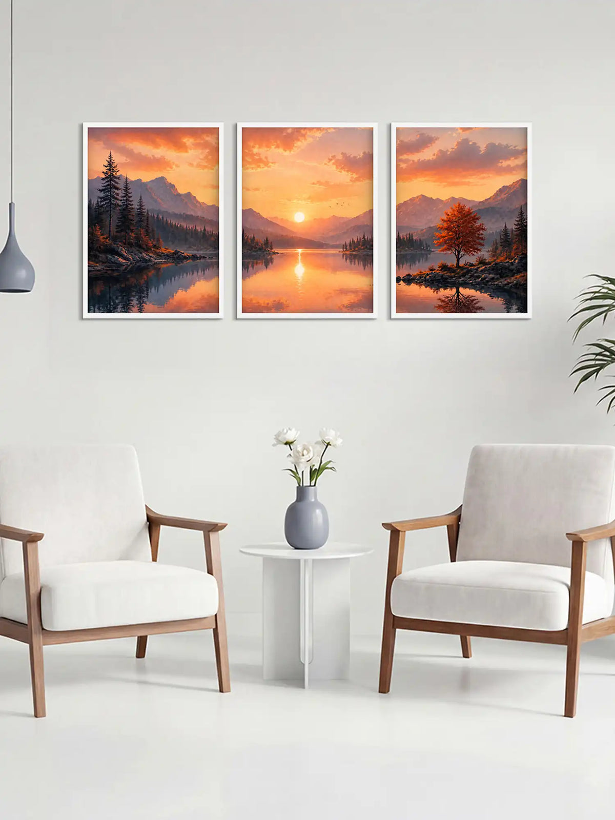 Three framed landscape prints of a sunset over a lake in a living room setting.