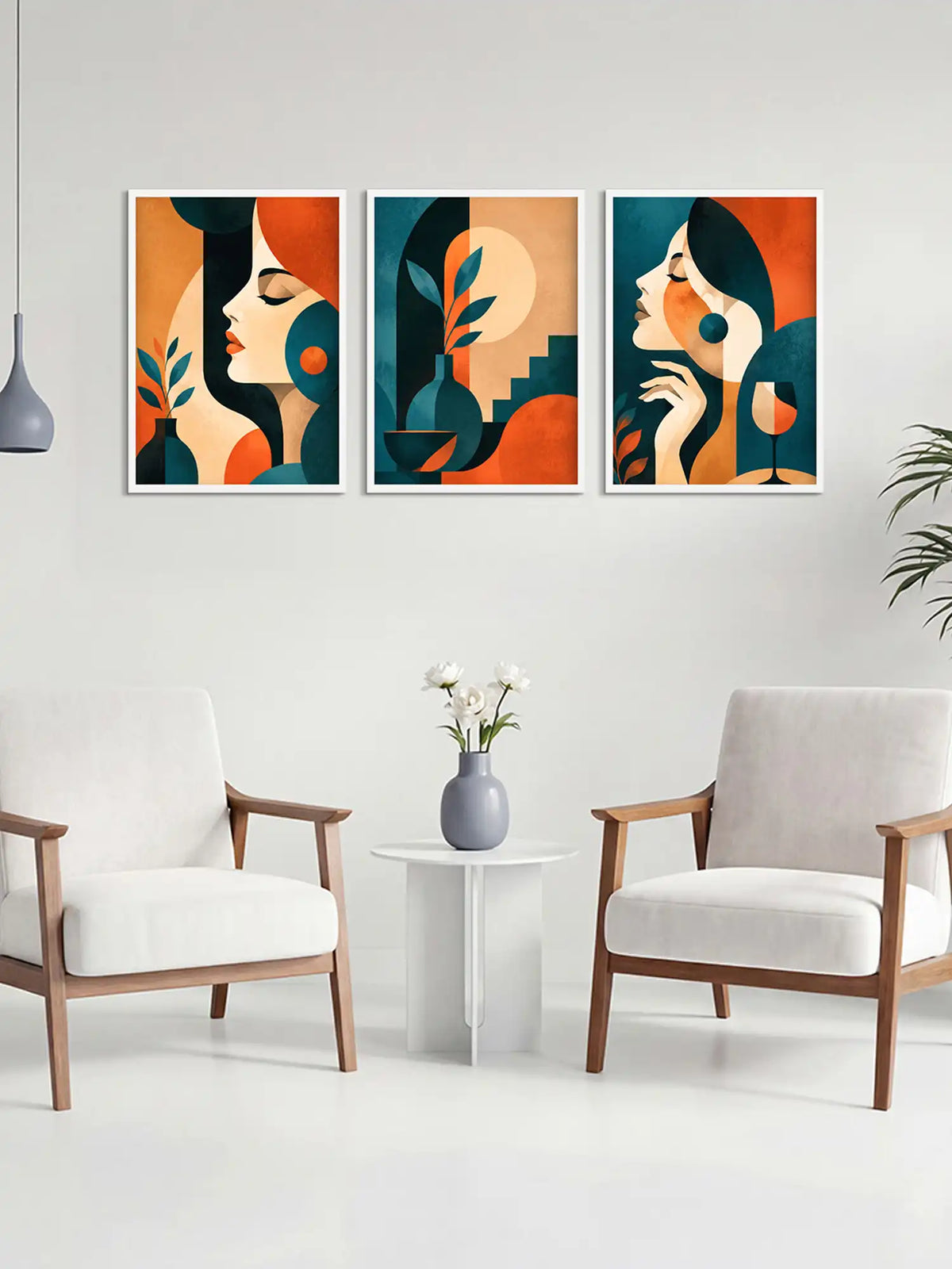 Three abstract art prints of women's faces on a wall above a white table with a vase and flowers, flanked by two chairs.