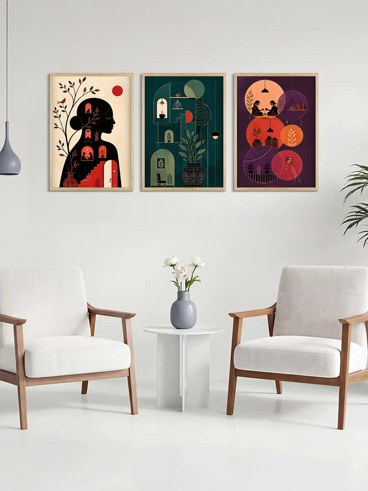 Three colorful framed artworks on a wall above a white table with a vase and flowers, flanked by two white chairs.