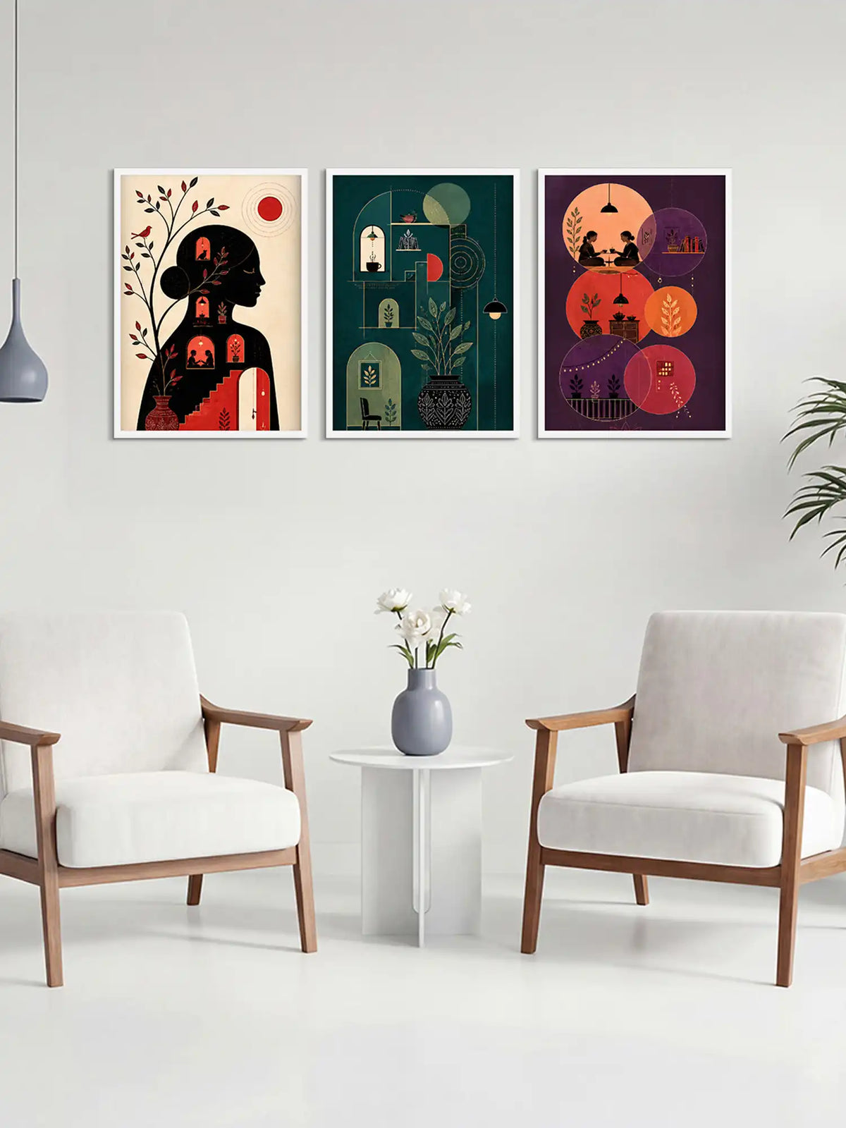 Three colorful abstract art prints on a wall above a white table with a vase and flowers, flanked by two white chairs.