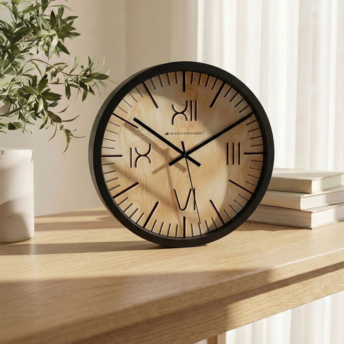 Natural wood finish wall clock with black border on a stylish tabletop